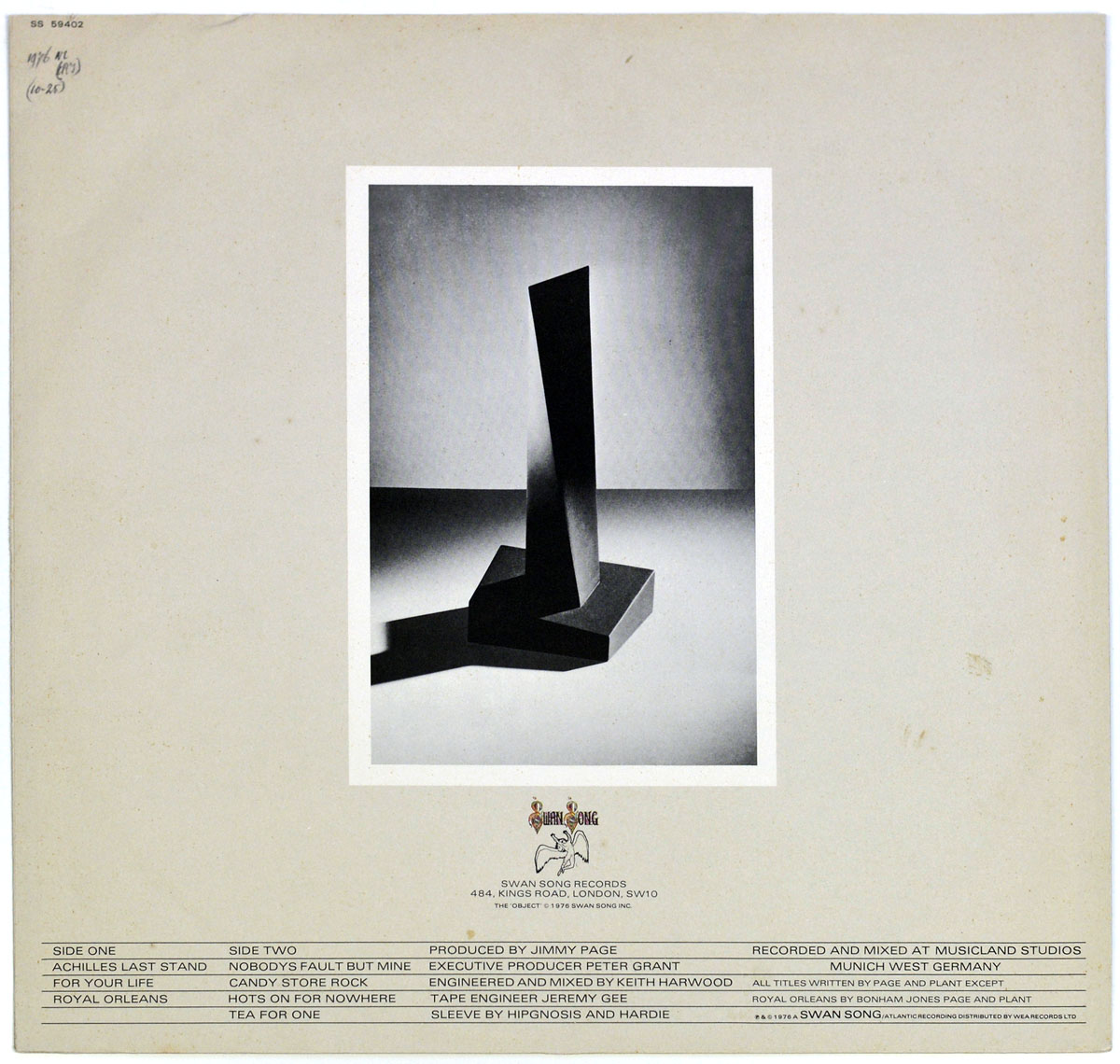 Alternate back cover of Led Zeppelin's 'Presence' album, featuring a black-and-white photograph of the mysterious black obelisk-like object casting a sharp shadow. Below, the track listing, production credits, and the Swan Song Records logo are displayed.